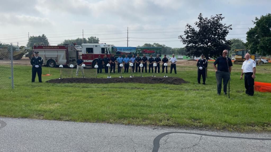 The groundbreaking site with helmets and shovels