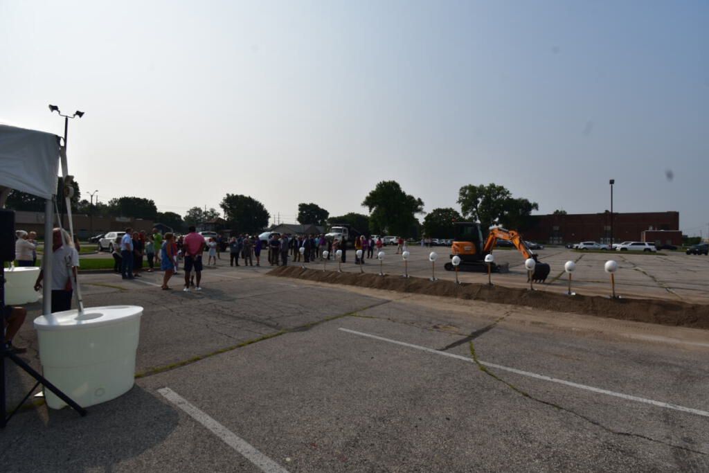 A row of dirt with Weigand hardhats and shovels.